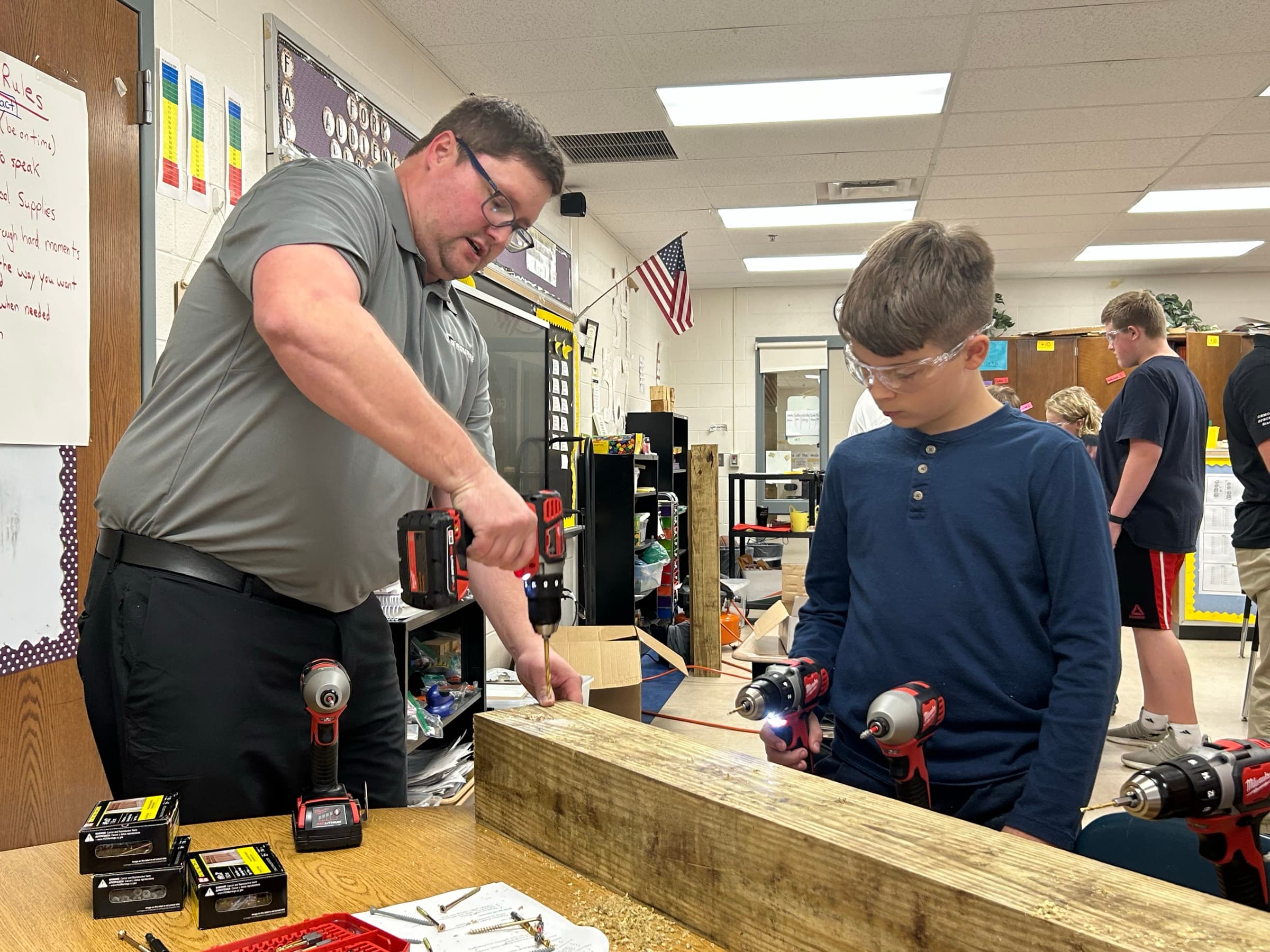 A workforce-development leader mentoring a student in a Northern Kentucky trades setting